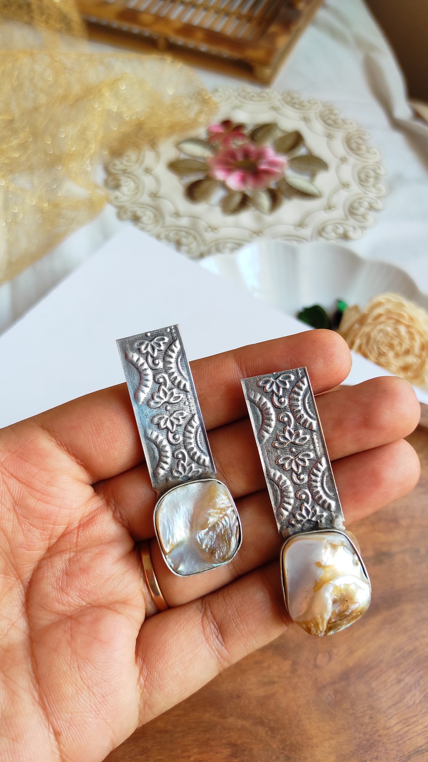 Embossed silver replica studs