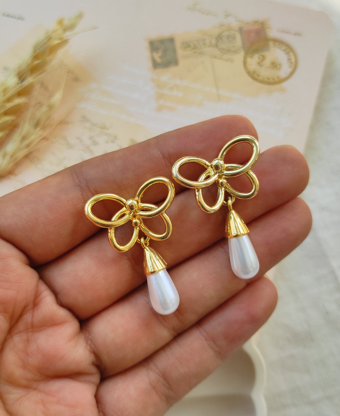 Butterfly tear drop pearl earrings