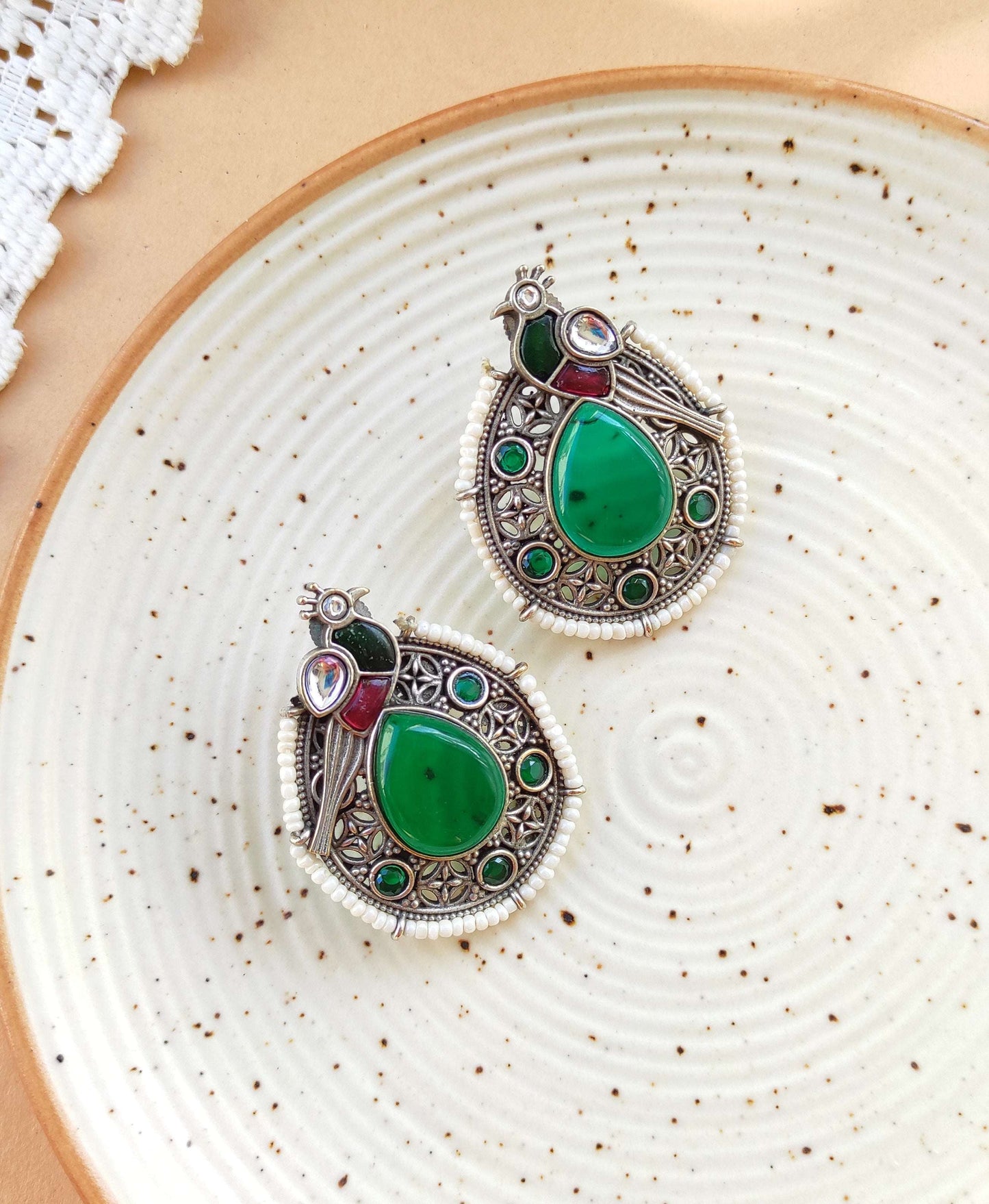 Peacock intricate work studs earrings in silver lookalike brass