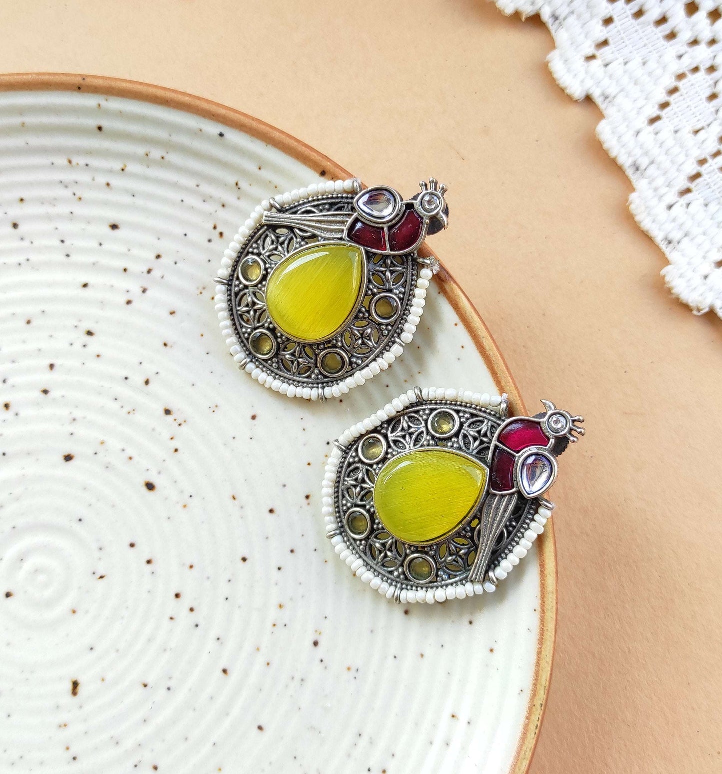 Peacock intricate work studs earrings in silver lookalike brass