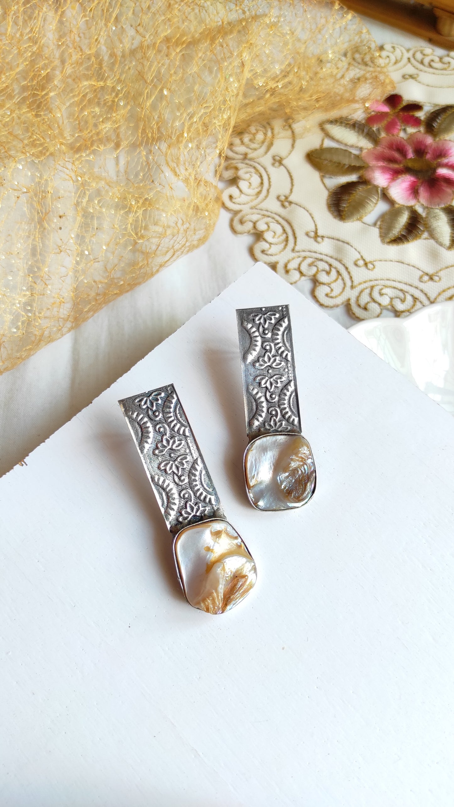 Embossed silver replica studs