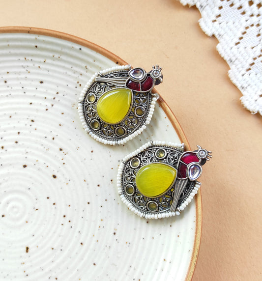 Peacock intricate work studs earrings in silver lookalike brass